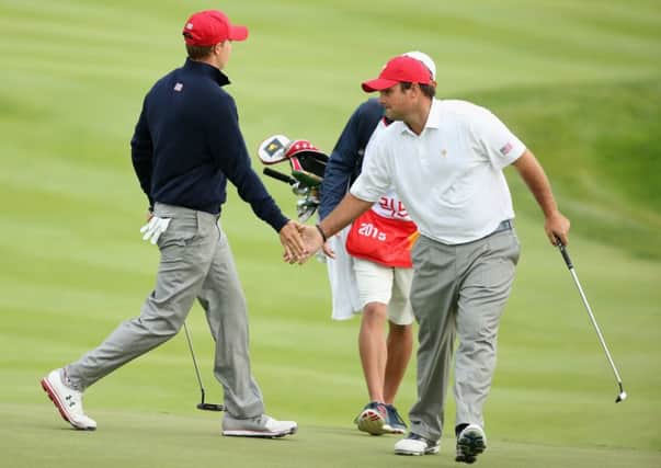 Jordan Spieth of the US celebrates with partner Patrick Reed after a birdie putt on the ninth during the Saturday afternoon four-ball win over International pair Jason Day and Charl Schwartzel  at the Presidents Cup.  Picture: Scott Halleran/Getty Images