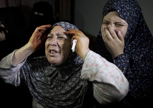 Women weep at the funeral of Noor Hassan and her daughter, Rahaf, in Gaza. Picture: AP