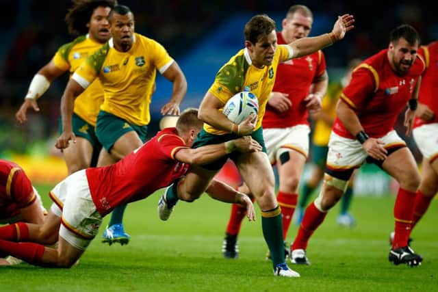 Australia's Bernard Foley is tackled by Gareth Anscombe of Wales at Twickenham Stadium. Picture: Getty Images