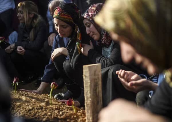 Family members mourn near the coffin of a victim of the twin bombings in Ankara, during the victims funeral in Istanbul. Picture: Getty