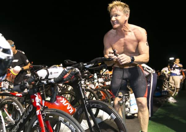 Ramsay prepares his bike in the race before collapsing. Picture: AP