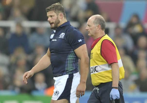 Injured Ross Ford is escorted from the field by Doctor Robson, Scotland have been blessed by a low casualty rate so far in this World Cup. Picture: Ian Rutherford