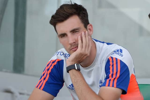 A dejected Steven Finn sits out England training yesterday. Picture: Getty