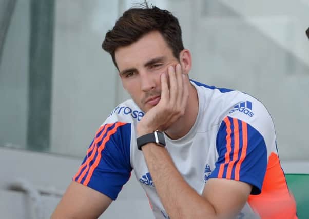 A dejected Steven Finn sits out England training yesterday. Picture: Getty