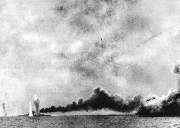 HMS Lion, left, is shelled and HMS Queen Mary, right, is blown up by German shells during the Battle of Jutland. Picture: Getty