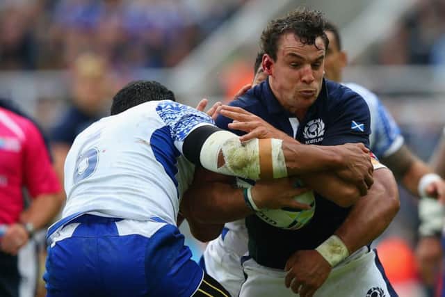 John Hardie is tackled by Marie Faasavalu during Scotlands thrilling victory over Samoa on Saturday. Picture: Getty