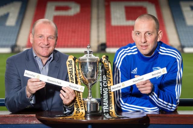 Queens Park manager Gus MacPherson, left, with Peterheads Graeme Smith at yesterdays Petrofac Training Cup semi-final draw. Picture: SNS