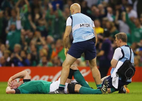 Paul OConnell lies in agony after suffering a torn hamstring injury in Irelands 24-9 victory over the French at Millennium Stadium on Sunday. Picture: Getty