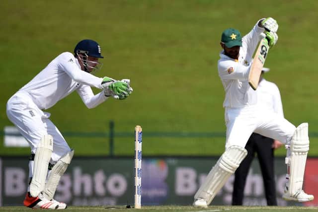 Shoaib Malik plays a shot off the back foot in his innings of 245 as England wicket-keeper Jos Buttler watches from behind the stumps. Picture: AP