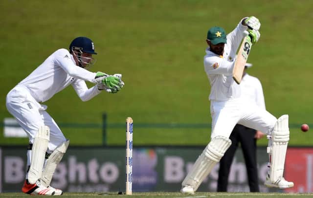 Shoaib Malik plays a shot off the back foot in his innings of 245 as England wicket-keeper Jos Buttler watches from behind the stumps. Picture: AP