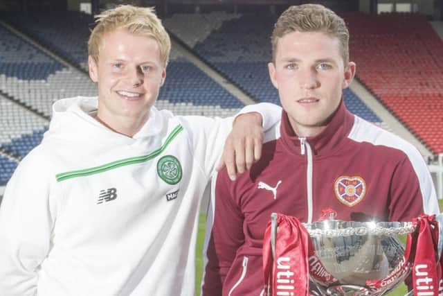 Celtic's Gary Mackay-Steven and Jack Hamilton of Hearts pose with the League Cup yesterday. Picture: Jeff Holmes