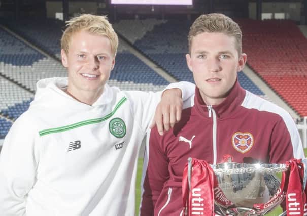 Celtic's Gary Mackay-Steven 
and Jack Hamilton of Hearts pose with the League Cup yesterday. Picture: Jeff Holmes