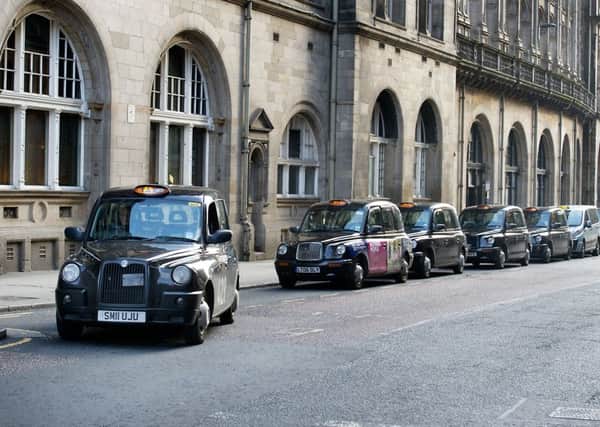 Glasgows black cabs are to face competition from Uber taxis from today. Picture: John Devlin