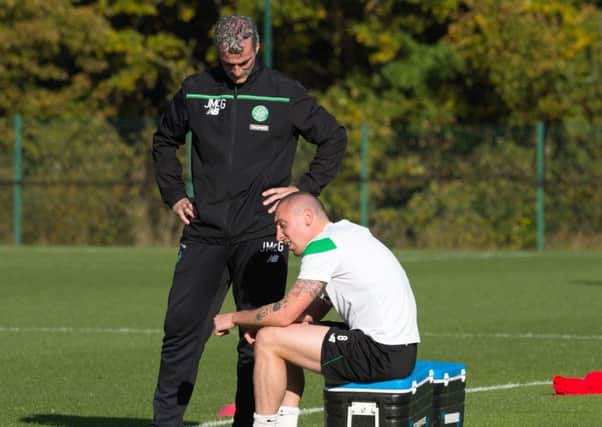 A disconsolate-looking Scott Brown with Celtic coaching consultant Jim McGuinness yesterday. Picture: SNS
