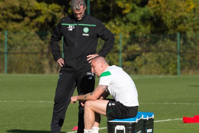 A disconsolate-looking Scott Brown with Celtic coaching consultant Jim McGuinness yesterday. Picture: SNS