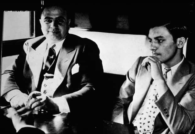 On this day in 1931 US gangster Al Capone, left, was imprisoned for tax evasion at the age of 33. Picture: Getty