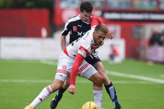 Dundee's Paul McGinn (right) challenges Gramoz Kurtaj. Picture: SNS