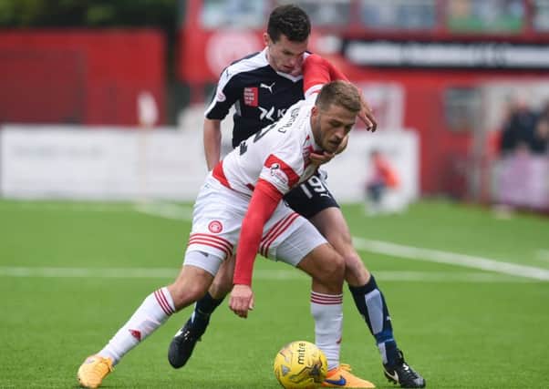 Dundee's Paul McGinn (right) challenges Gramoz Kurtaj. Picture: SNS