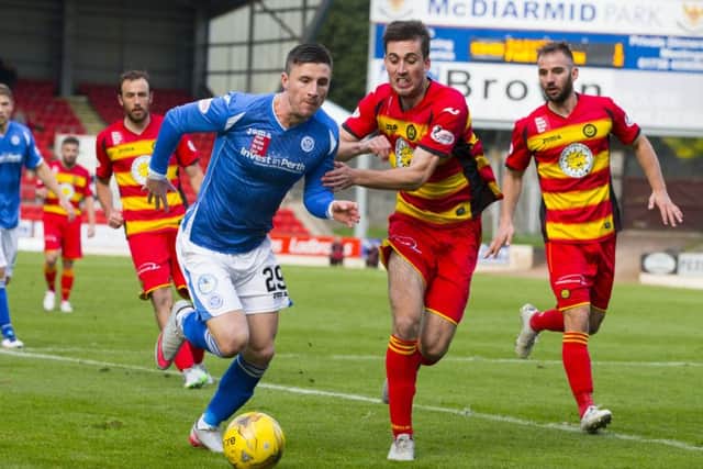 St Johnstone's Michael O'Halloran (left) and Partick's Callum Booth battle for possession. Picture: SNS