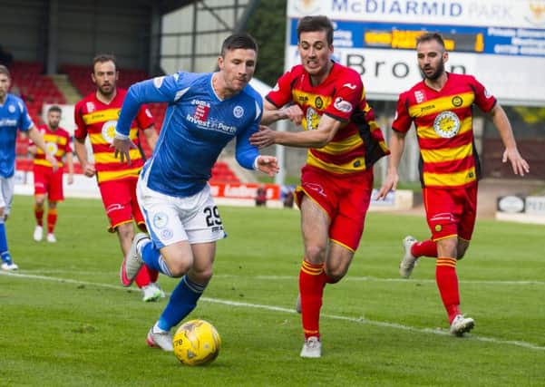 St Johnstone's Michael O'Halloran (left) and Partick's Callum Booth battle for possession. Picture: SNS