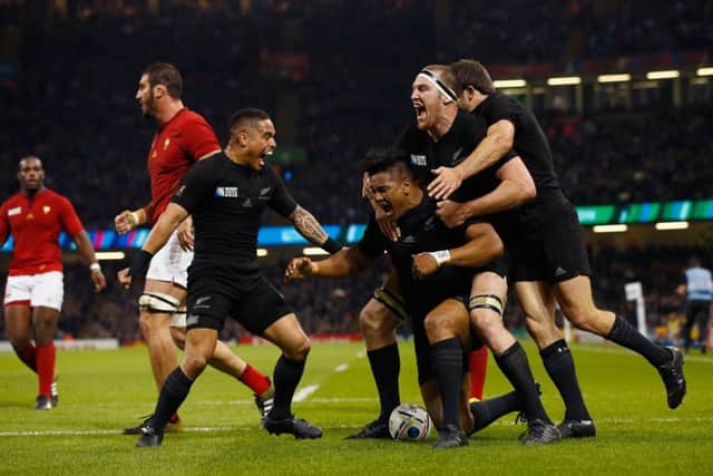 New Zealand players celebrate with try scorer Julian Savea, who went on to bag a hat-trick. Picture: Stu Forster/Getty Images