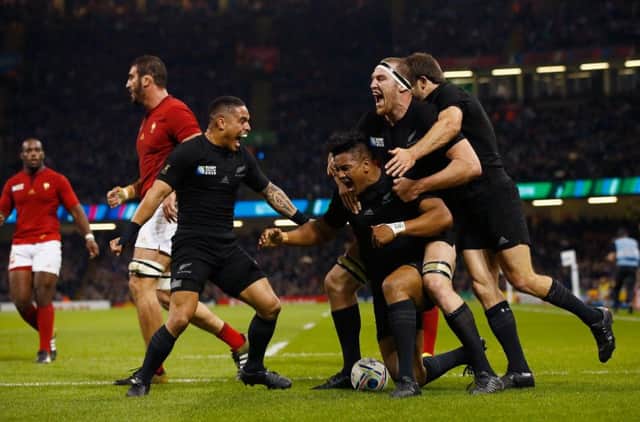 New Zealand players celebrate with try scorer Julian Savea, who went on to bag a hat-trick. Picture: Stu Forster/Getty Images