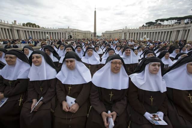 Nuns wait for the arrival of Pope Francis at the canonisation. Picture: AP