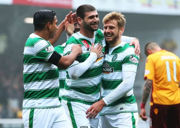 Nadir Ciftci celebrates his winning goal against Motherwell with Celtic team-mates Emilio Izaguirre and Stuart Artmstrong. Picture: Getty