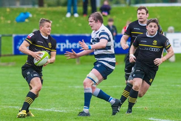 Clarke Smith, of Heriot's, moves in to tackle Tom Galbraith during Saturday's clash at The Greenyards. Picture: Ian Georgeson