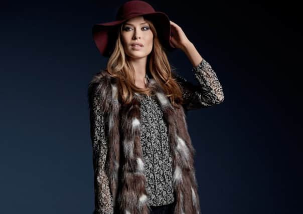 Faux Fur Gilet, Bubble Hem Gypsy Shirt, Jeans and Fedora Hat, all available from M&Co. Picture: PA