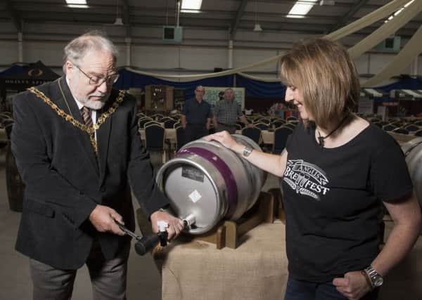 20151017- Angus Brewfest at Strathmore Hall, Forfar. 
Angus Deputy Provost Alex King taps the the first barrel of Kirrie Ales beer watched by Angus Brewfest organiser Carol Robbie.  

Copyright Andy Thompson Photography / ATIMAGES 

No use without payment.