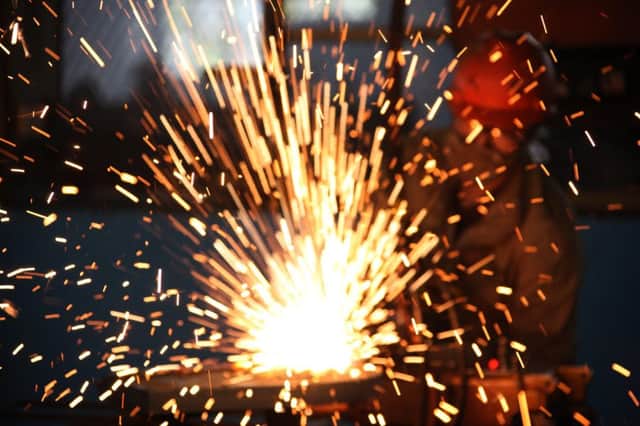 A worker welds steel in a factory in Huaibei, in north China's Anhui province. Picture: Getty