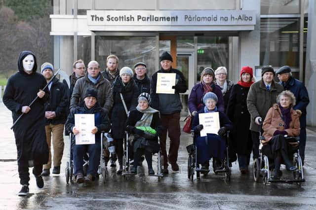A wheelchair protest greets MSPs as they arrived at the Scottish Parliament to consider the latest bid to introduce assisted suicide. Picture: Gordon Fraser