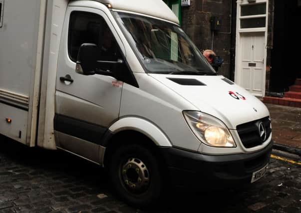 The G4S van tipped over with four people inside. Picture: Ian Rutherford