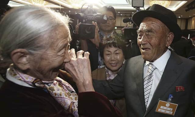 South Korean Lee Soon-kyu , left, meets  North Korean husband Oh Se In. Picture: AP