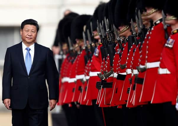 China's President Xi Jinping reviews an honour guard on his state visit to the United Kingdom. Picture: Getty