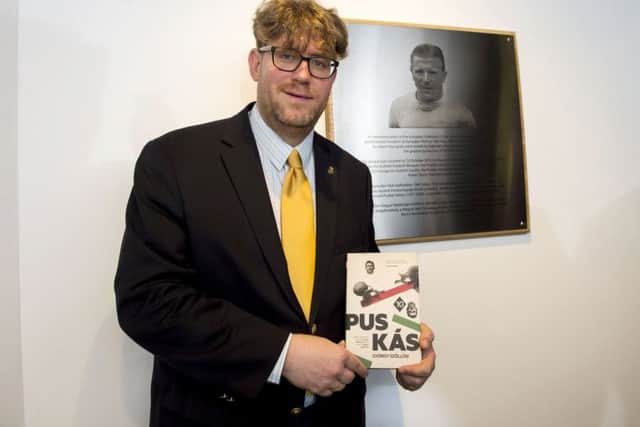 Author Gyorgy Szollosi with his book on Puskas and the plaque dedicated to the 1960 European Cup final at Hampden. Picture: SNS