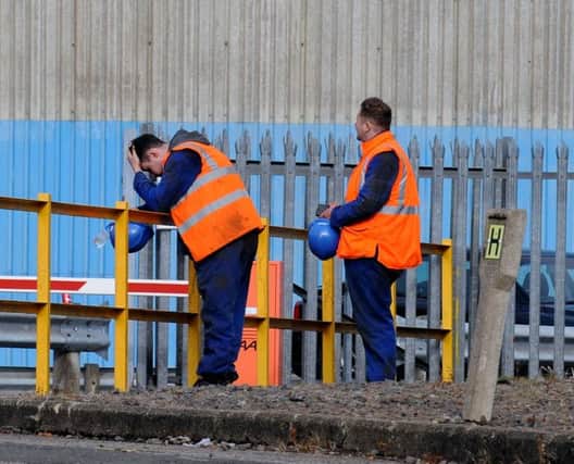 Workers yesterday as the job losses were announced at the steel plants. Picture: Lisa Ferguson