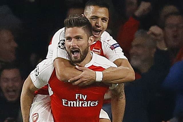 Arsenals French striker Olivier Giroud, front, celebrates his opening goal with Alexis Sanchez. Picture: AP