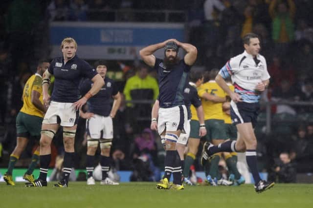 Jonny Gray, left, and Josh Strauss, center, watch Craig Joubert as he runs off the pitch. Picture: AP