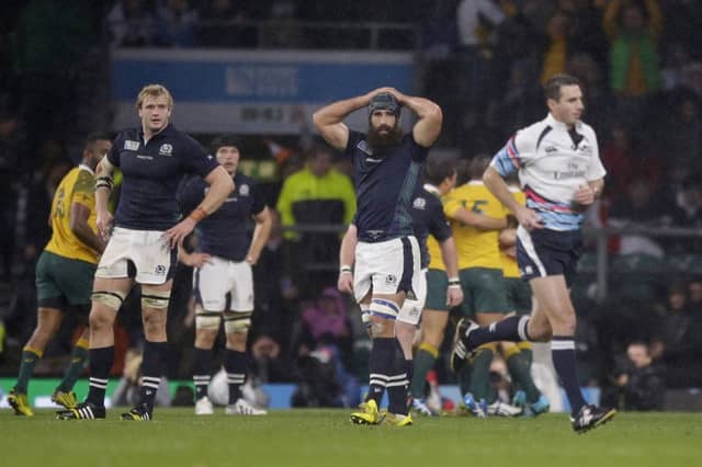 Jonny Gray, left, and Josh Strauss, center, watch Craig Joubert as he runs off the pitch. Picture: AP