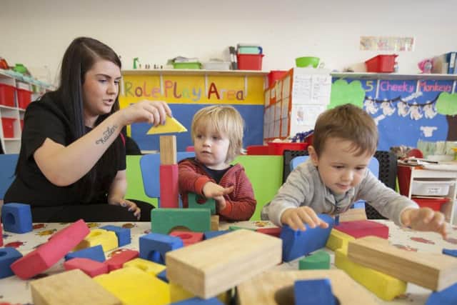 Nursery nurse Melissa McBride with some of the children at Victoria Park Kindergarten. Picture: Chris James