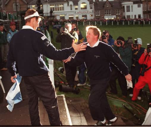 Andrew Coltart congratulates teammate Colin Montgomerie after Scotland beat Zimbabwe to win the Alfred Dunhill Cup  on this day in 1995 in St Andrews. Picture: Getty