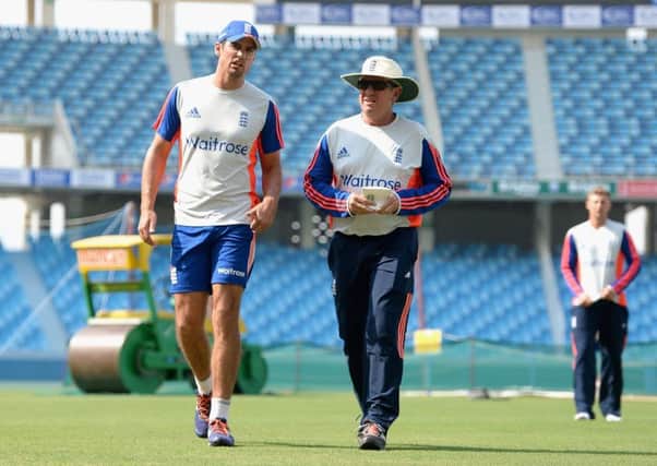 England captain Alastair Cook and coach Trevor Bayliss during a nets session at Dubai Cricket Stadium yesterday.  Picture: Getty Images