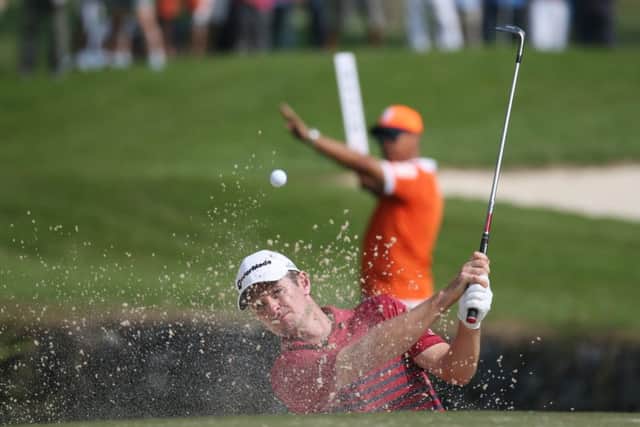 Justin Rose blasts out of a bunker at the third hole during the second round at the Hong Kong Open. Picture: AP