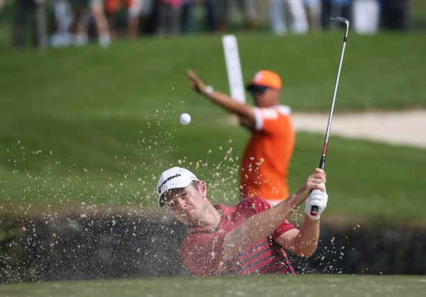Justin Rose blasts out of a bunker at the third hole during the second round at the Hong Kong Open. Picture: AP