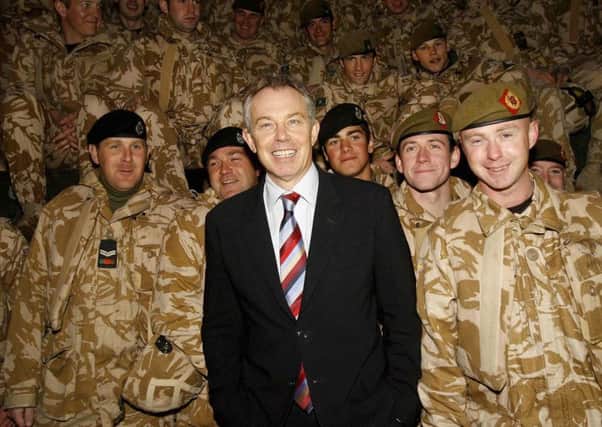 Tony Blair poses with British troops in Basra while on a prime ministerial visit to Iraq in 2006. Picture: AFP/Getty Images