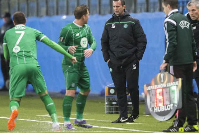 Celtic's manager Ronny Deila talks to Kris Commons during the side's Europa League Group A soccer match against Molde. Picture: AP