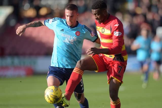 Antons Kurakins (left) battles for the ball with Partick's David Amoo. Picture: SNS Group