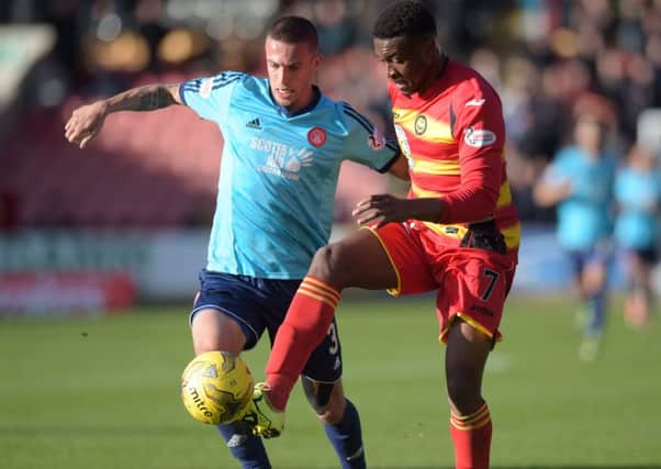 Antons Kurakins (left) battles for the ball with Partick's David Amoo. Picture: SNS Group